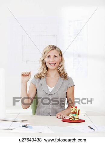 Businesswoman with good luck charm View Large Photo Image Stock Photo - Businesswoman with good luck charm. Fotosearch
