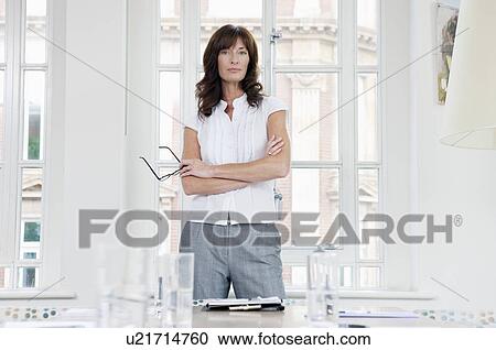 Stock Image - Businesswomen at head of the table. Fotosearch