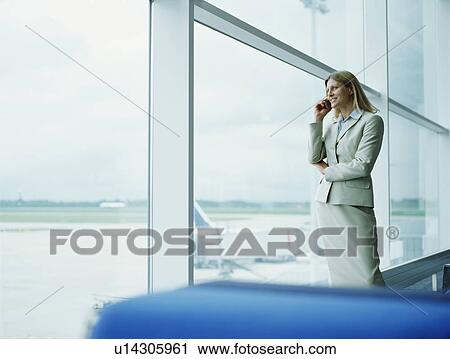 Stock Image - Businesswomen using mobile. Fotosearch
