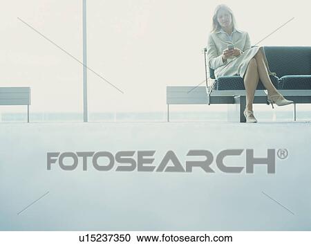 Stock Image - Businesswomen using mobile. Fotosearch