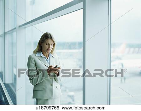 Businesswomen using mobile View Large Photo Image Stock Photograph - Businesswomen using mobile. Fotosearch