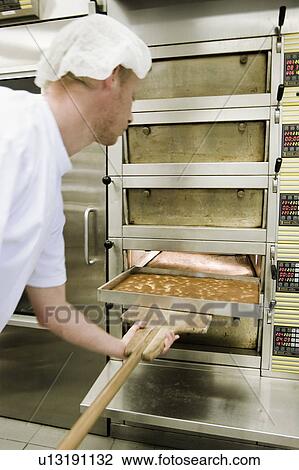 Cake taken out of an oven View Large Photo Image Stock Image - Cake taken out of an oven. Fotosearch