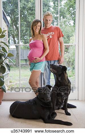 Caucasian pregnant couple and dogs View Large Photo Image Stock Image - Caucasian pregnant couple and dogs. Fotosearch