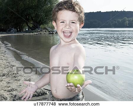child holding apple by river View Large Photo Image Stock Photo - child holding apple by river. Fotosearch