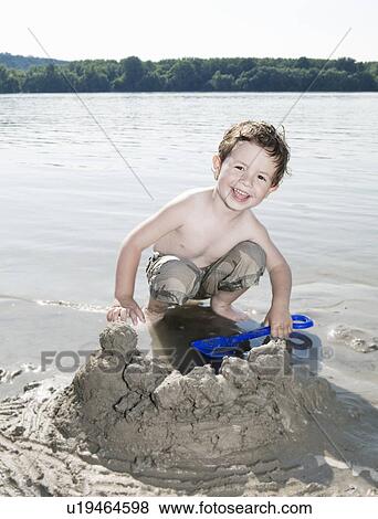 Stock Photo - child playing with sand. Fotosearch