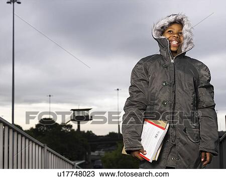 Stock Image - child walking with books. Fotosearch