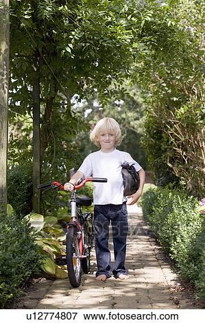 Stock Photo - child with first bicycle. Fotosearch