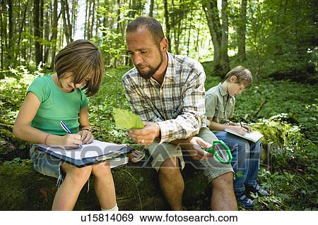 Stock Photo - children and teacher in the wood. Fotosearch