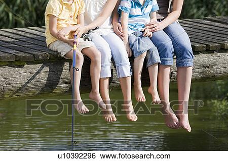 Stock Photograph - children fishing from footbridge. Fotosearch