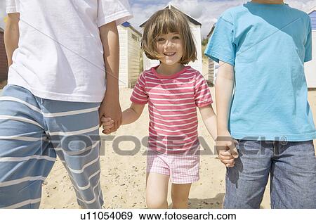 Children holding hands on beach View Large Photo Image Stock Photo - Children holding hands on beach. Fotosearch