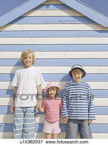 Stock Photo - Children in front of beach hut. Fotosearch