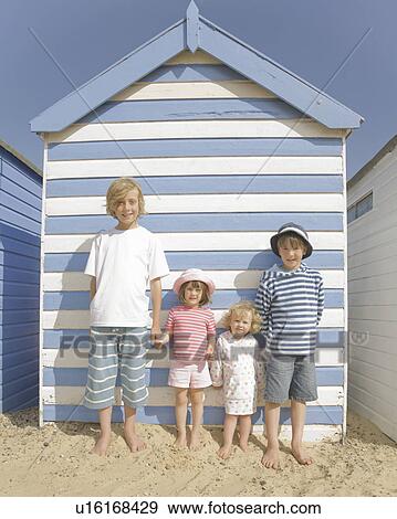 Stock Photo - Children in front of beach hut. Fotosearch