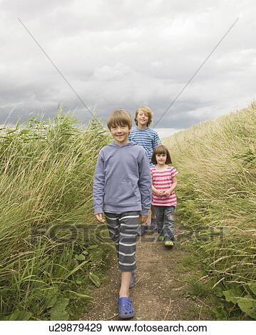 Children walking down path View Large Photo Image Stock Photo - Children walking down path. Fotosearch
