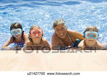 Children with a senior female in a pool View Large Photo Image Stock Image - Children with a senior female in a pool. Fotosearch