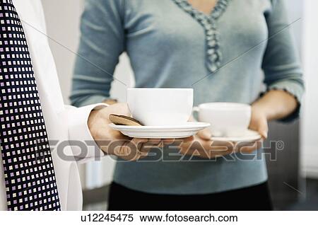 Stock Photography - Close up of a coffee cup and biscuit. Fotosearch