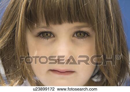 Stock Image - Close up portrait of young girls face. Fotosearch