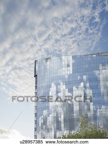 Stock Photography - Clouds reflected in building. Fotosearch