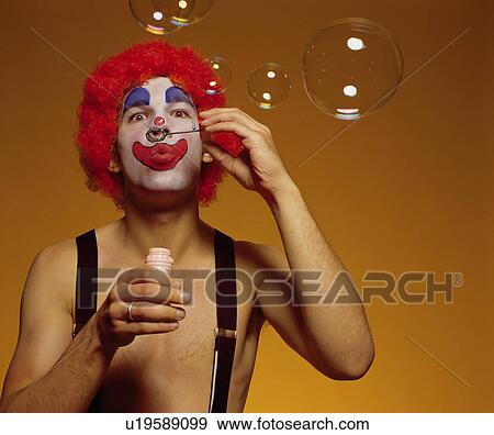 Stock Photo - clown blowing bubbles. Fotosearch