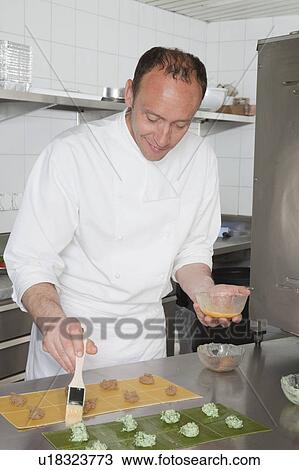cook filling pasta, concentrated View Large Photo Image Stock Image - cook filling pasta, concentrated. Fotosearch
