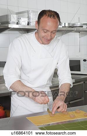 Stock Image - cook filling pasta. Fotosearch