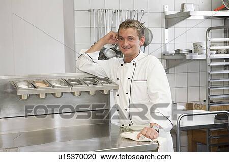 Stock Image - cook polishing, smiling. Fotosearch