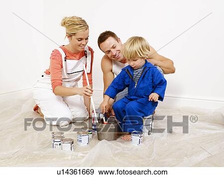 Couple and boy mixing paint in bucket View Large Photo Image Stock Photo - Couple and boy mixing paint in bucket. Fotosearch