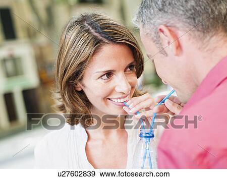couple drinking out of same glass View Large Photo Image Stock Photo - couple drinking out of same glass. Fotosearch