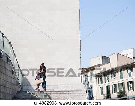 couple embracing at top of stairs View Large Photo Image Stock Image - couple embracing at top of stairs. Fotosearch