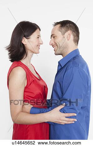 Stock Image - couple embracing each other smiling. Fotosearch