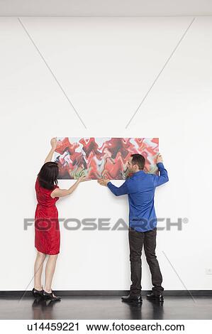 couple hanging up a picture View Large Photo Image Stock Image - couple hanging up a picture. Fotosearch
