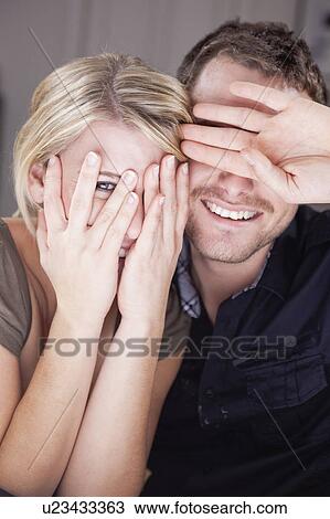 couple hiding behind their hands View Large Photo Image Stock Image - couple hiding behind their hands. Fotosearch