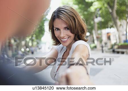 couple holding hands in the street View Large Photo Image Stock Image - couple holding hands in the street. Fotosearch