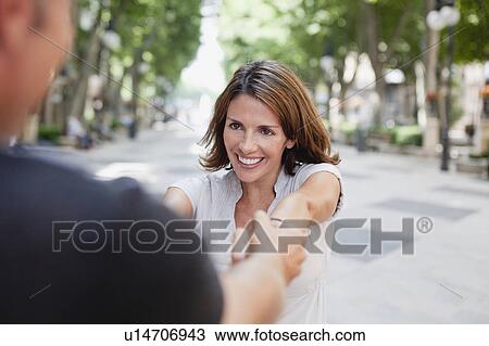 couple holding hands in the street View Large Photo Image Stock Image - couple holding hands in the street. Fotosearch