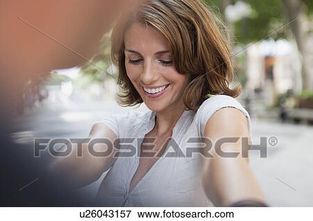 couple holding hands in the street View Large Photo Image Stock Photo - couple holding hands in the street. Fotosearch