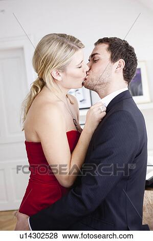 Stock Photo - couple hugging and kissing. Fotosearch