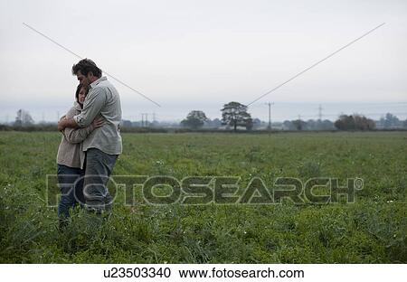 couple hugging in field View Large Photo Image Stock Image - couple hugging in field. Fotosearch