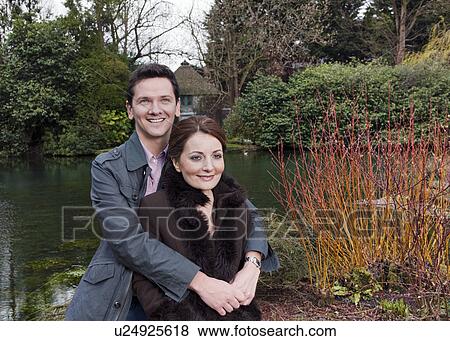 Stock Photo - couple hugging on riverside. Fotosearch