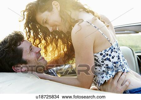 Couple in a convertible View Large Photo Image Picture - Couple in a convertible. Fotosearch