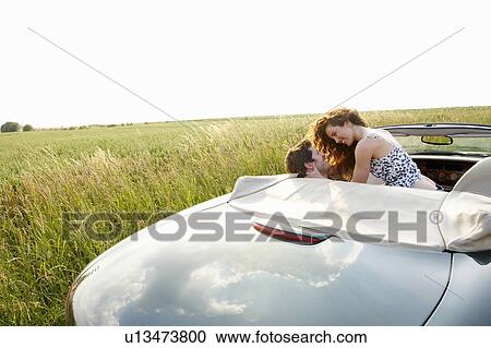Couple in a convertible View Large Photo Image Stock Image - Couple in a convertible. Fotosearch