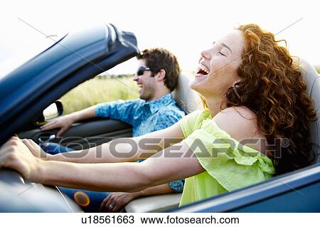 Stock Image - Couple in a convertible. Fotosearch