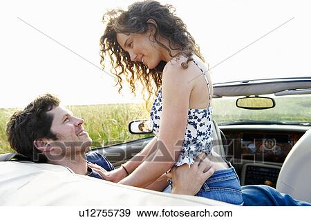 Couple in a convertible View Large Photo Image Stock Photo - Couple in a convertible. Fotosearch