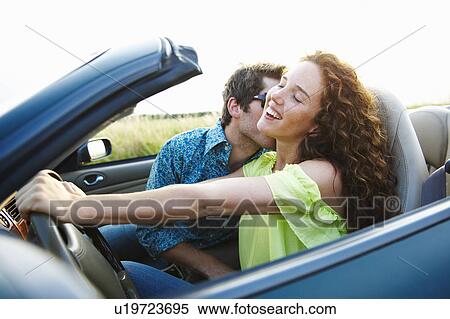 Stock Photography - Couple in a convertible. Fotosearch