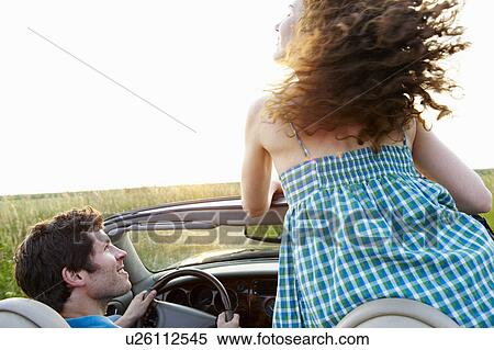 Couple in a convertible View Large Photo Image Stock Photography - Couple in a convertible. Fotosearch