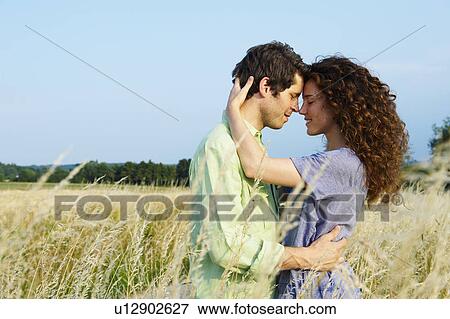Couple in a wheat field View Large Photo Image Stock Photo - Couple in a wheat field. Fotosearch