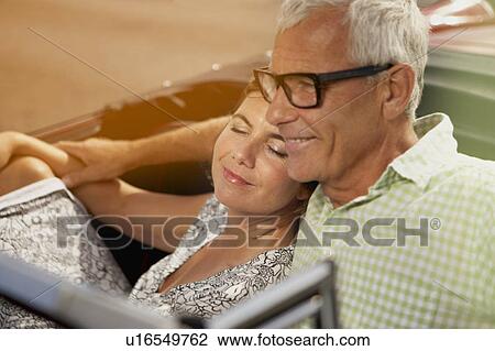 Couple in car, her head on shoulder View Large Photo Image Stock Image - Couple in car, her head on shoulder. Fotosearch