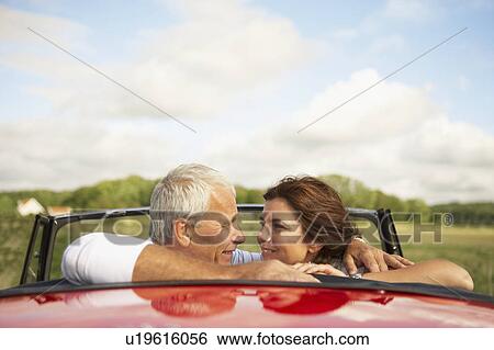 Stock Photograph - Couple in car, over shoulder. Fotosearch