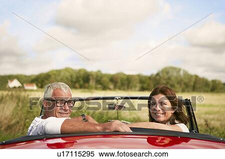 Stock Photography - Couple in car, over shoulder. Fotosearch
