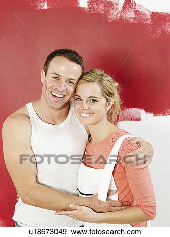 Couple in front of newly painted wall View Large Photo Image Stock Photo - Couple in front of newly painted wall. Fotosearch
