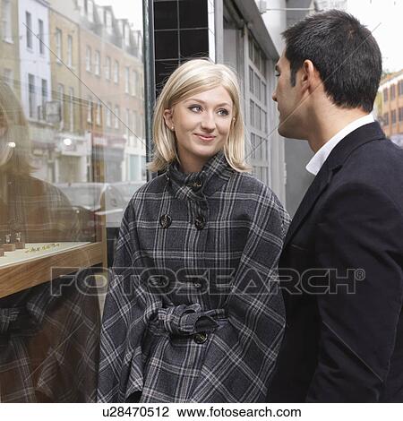 Stock Image - couple in front of shop window. Fotosearch