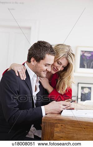 couple inspecting phone together View Large Photo Image Stock Image - couple inspecting phone together. Fotosearch